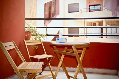 a table and two chairs sitting next to a window at Nelbrj Studio in Marrakech