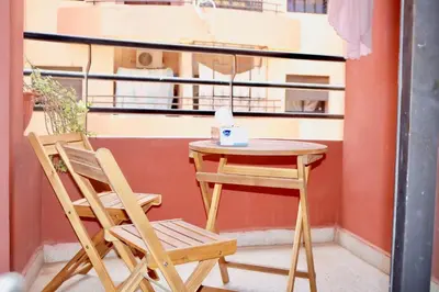 a table and two chairs on a balcony with a table and a table at Nelbrj Studio in Marrakech