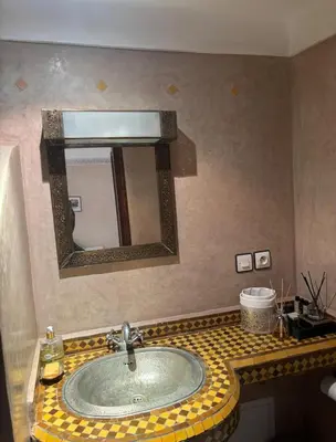a bathroom with a sink and a mirror at Échappée onirique au cœur de Marrakech in Marrakech