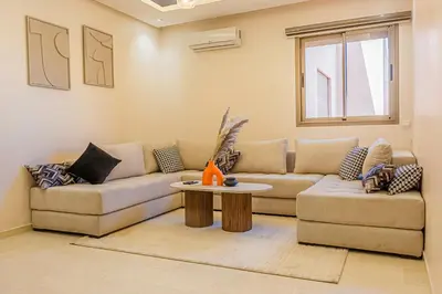 a living room with a couch and a table at 2 bedrooms appartement les palmiers de targa in Marrakech