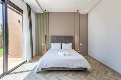 a bedroom with a bed and a large window at Family villa in Marrakech in Marrakech