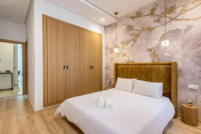 a bedroom with a white bed with two white shoes on it at Family villa in Marrakech in Marrakech