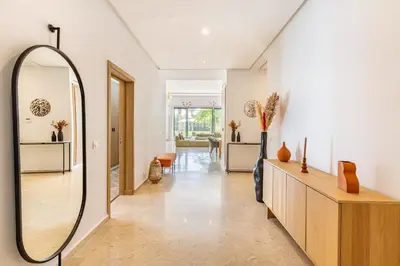 a hallway with a mirror and a living room at Family villa in Marrakech in Marrakech