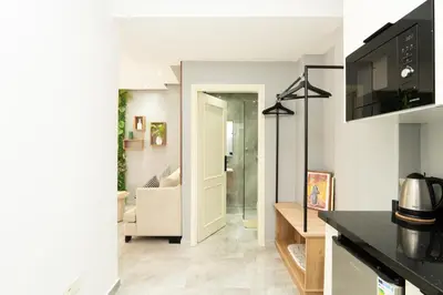 a kitchen and a living room with a couch at Luxury Balnéo appartement in Marrakech