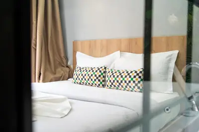 a bed with two pillows on top of it at Luxury Balnéo appartement in Marrakech