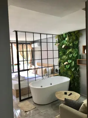 a bath tub in a room with a bedroom at Luxury Balnéo appartement in Marrakech