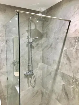 a shower with a glass door in a bathroom at Luxury Balnéo appartement in Marrakech