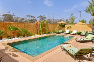 a swimming pool with chaise lounge chairs and a swimming pool at Villa Dar Soka in Marrakech