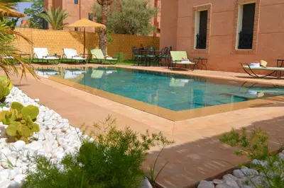 a swimming pool in a yard with chairs and tables at Villa Dar Soka in Marrakech