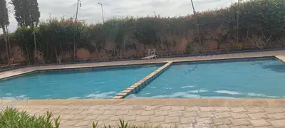 a swimming pool with a chair in front of a wall at premium village m231 in Marrakech