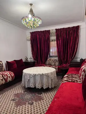 a living room with a couch and a table at Dar MI HNIA in Marrakech