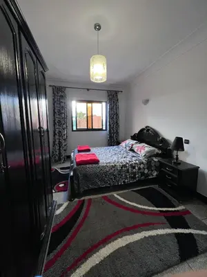 a bedroom with a bed and a dresser and a window at Dar MI HNIA in Marrakech