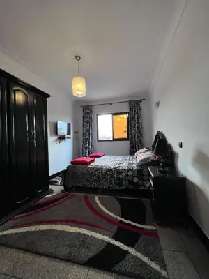 a bedroom with a bed and a window at Dar MI HNIA in Marrakech