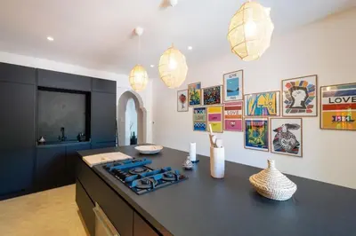 a kitchen with a black counter top with a stove at Villa ÈME in Marrakech