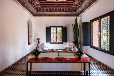 a living room with a couch and windows at Villa ÈME in Marrakech