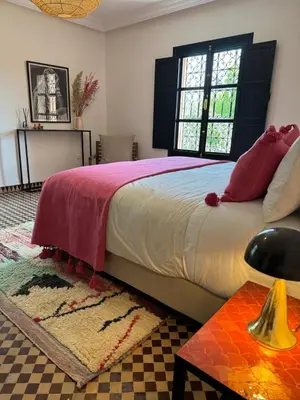 a bedroom with a large bed and a window at Villa ÈME in Marrakech