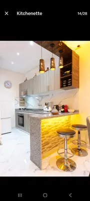 a kitchen with a counter and two bar stools at Appartement limoen in Marrakech