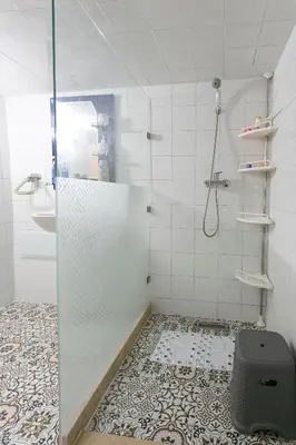 a shower with a glass door in a bathroom at Appartement limoen in Marrakech