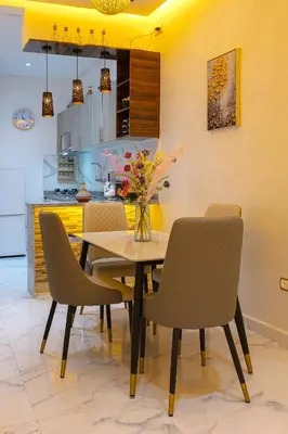 a dining room with a table and chairs at Appartement limoen in Marrakech