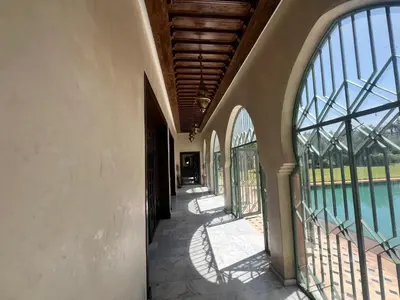 an empty hallway of a house with large windows at Villa de Charme avec Piscine, Hammam & Jardin Enchanté in Marrakech
