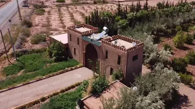 an aerial view of a building in the middle of a field at Villa de Charme avec Piscine, Hammam & Jardin Enchanté in Marrakech