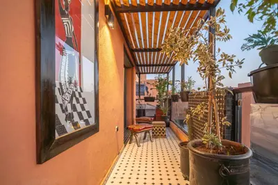a small balcony with potted plants on a building at Design Art Gallery Apartment Marrakech swimming pool on the Roof in Marrakech
