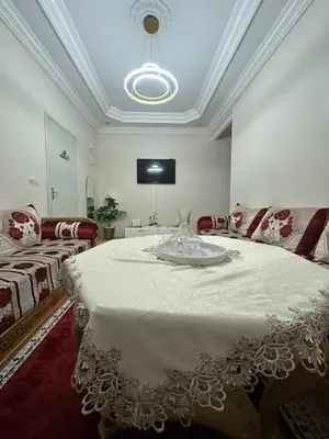 a living room with a large bed and a couch at Modern Comfort, Local Vibes in Marrakech