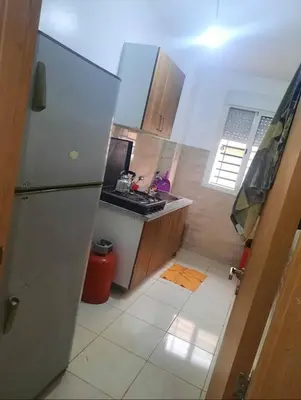 a small kitchen with a refrigerator and a sink at Shawna Home in Marrakech