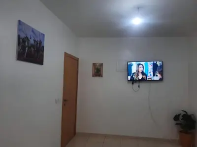 a flat screen tv on a white wall at Shawna Home in Marrakech