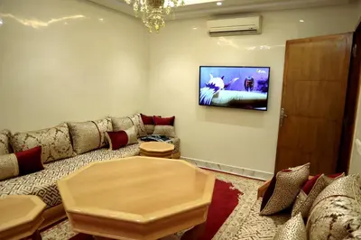 a living room with a couch and a tv on the wall at Medali in Lahebichate
