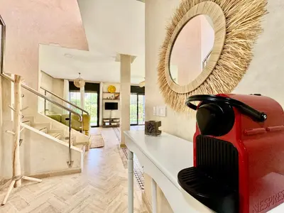 a room with a mirror and a red suitcase on a counter at Private Garden Villa - Rooftop, BBQ, Pools and Views in Marrakech