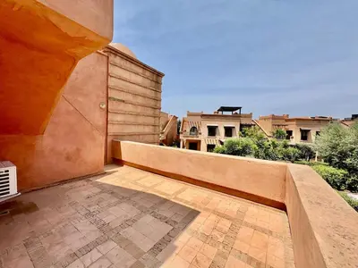 a balcony with a wooden fence and a building at Private Garden Villa - Rooftop, BBQ, Pools and Views in Marrakech