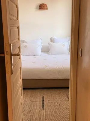 a bedroom with a bed with white sheets and pillows at PRIVATE HOUSE in Medina Close to Jeema El Fna in Marrakech