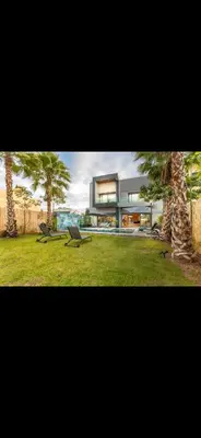 a large house with two palm trees in front of it at Marrakech Luxury Golf Villa Private Heated Pool & Garden Oasis in Marrakech