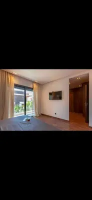 a bedroom with a bed and a large window at Marrakech Luxury Golf Villa Private Heated Pool & Garden Oasis in Marrakech