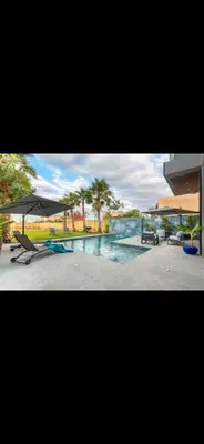 a picture of a swimming pool with an umbrella at Marrakech Luxury Golf Villa Private Heated Pool & Garden Oasis in Marrakech