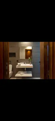 a bathroom with a sink and a toilet and a mirror at Marrakech Luxury Golf Villa Private Heated Pool & Garden Oasis in Marrakech