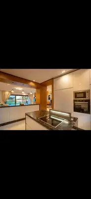 a kitchen with white cabinets and a counter top at Marrakech Luxury Golf Villa Private Heated Pool & Garden Oasis in Marrakech
