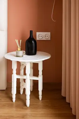 a white table with a black vase on top of it at Cosy, Bohème au cœur de Marrakech et de la medina in Marrakech