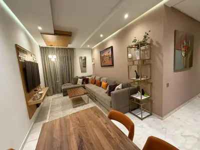a living room with a couch and a table at Luxury 2BDR AP in Central Marrakech Gueliz in Marrakech