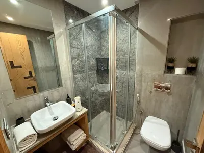 a bathroom with a shower and a sink and a toilet at Luxury 2BDR AP in Central Marrakech Gueliz in Marrakech