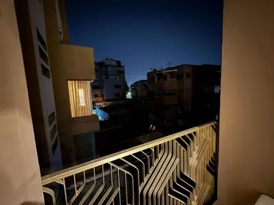 a balcony with a view of a city at night at Luxury 2BDR AP in Central Marrakech Gueliz in Marrakech