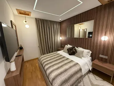 a hotel room with a bed and a television at Luxury 2BDR AP in Central Marrakech Gueliz in Marrakech