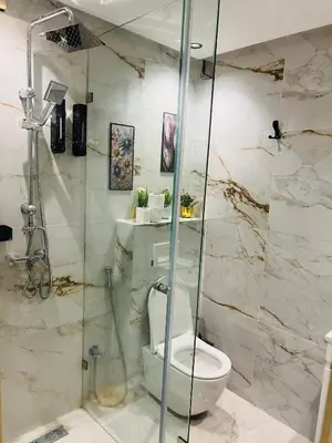a bathroom with a toilet and a glass shower at Monolocale l'alba Hevernage 1ch in Marrakech