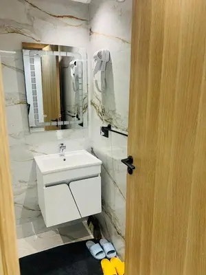 a bathroom with a white sink and a mirror at Monolocale l'alba Hevernage 1ch in Marrakech