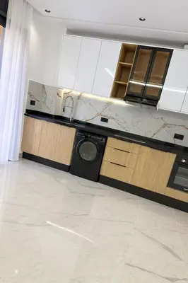 a kitchen with a washing machine in the middle at L'aube de l'éveinage 2 bedrooms Marrakech station in Marrakech