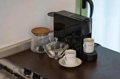 a coffee maker and two cups on a counter at Urban Pearl terrace and pool in Marrakech