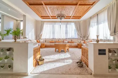 a living room with a couch and a table at Villa Traverta Marrakech, 5 Suites, Heated Pool, Workation & Authentic Hammam in Marrakech