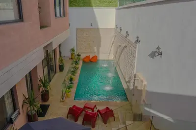 a swimming pool in the middle of a building at Villa Traverta Marrakech, 5 Suites, Heated Pool, Workation & Authentic Hammam in Marrakech