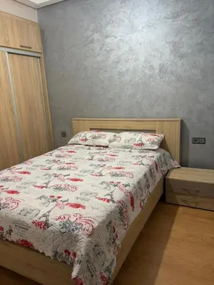 a bedroom with a bed with a red and white blanket at cozy and warm apartment in Marrakech